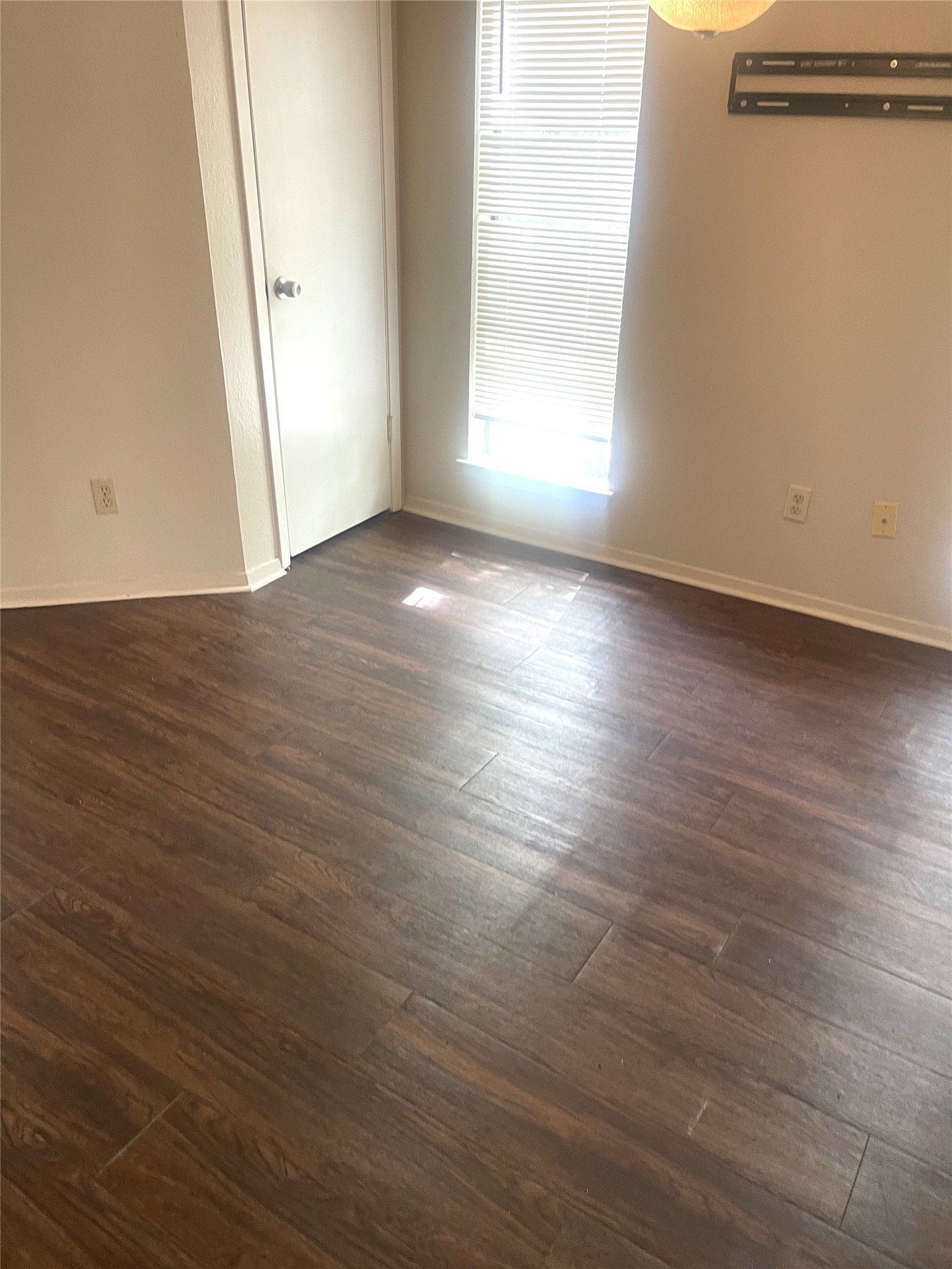 2005 West Loop, Unit D1 Austin, TX 78758 - Photo 23 of 31 an empty room with wooden floor and windows