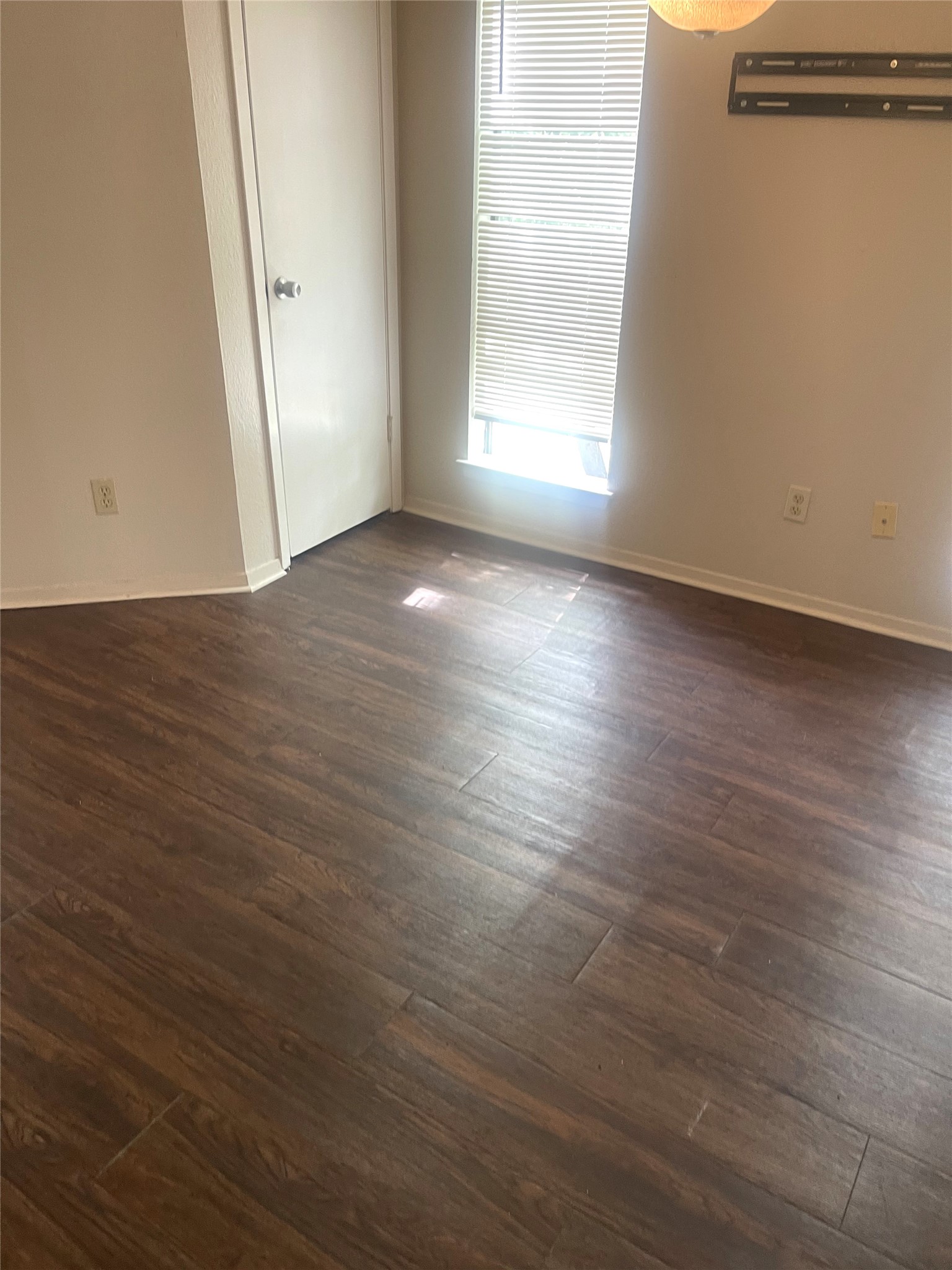 2005 West Loop, Unit D1 Austin, TX 78758 - Photo 25 of 31 an empty room with wooden floor and windows
