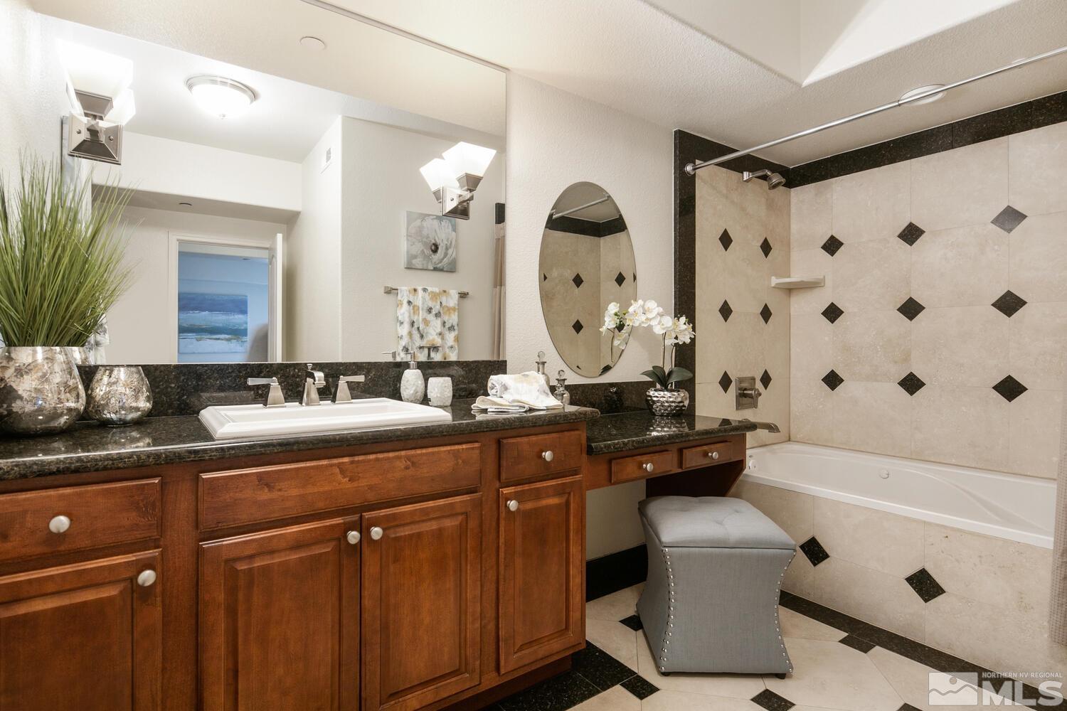 200 West 2nd Street, Unit 1507 Reno, NV 89501 - Photo 15 of 35 a bathroom with a sink mirror toilet and bathtub