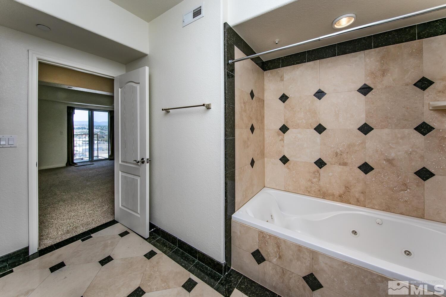 200 West 2nd Street, Unit 1507 Reno, NV 89501 - Photo 23 of 35 a bathroom with a tub and a shower