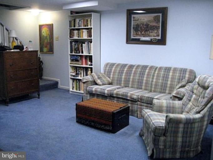 8417 Thames Street Springfield, VA 22151 - Photo 14 of 16 a living room with furniture and a book shelf