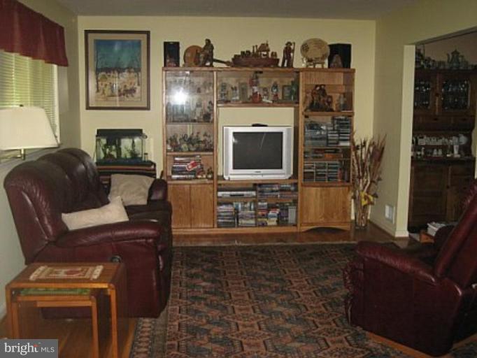 8417 Thames Street Springfield, VA 22151 - Photo 3 of 16 a living room with furniture and a flat screen tv