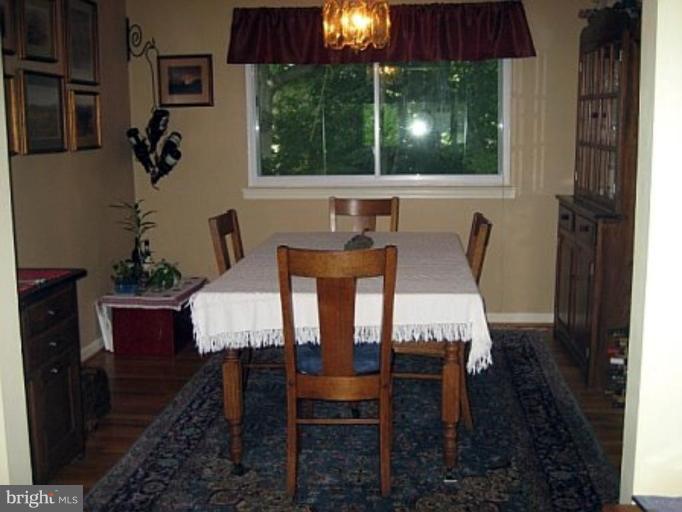 8417 Thames Street Springfield, VA 22151 - Photo 7 of 16 a view of a dining room with furniture wooden floor and chandelier