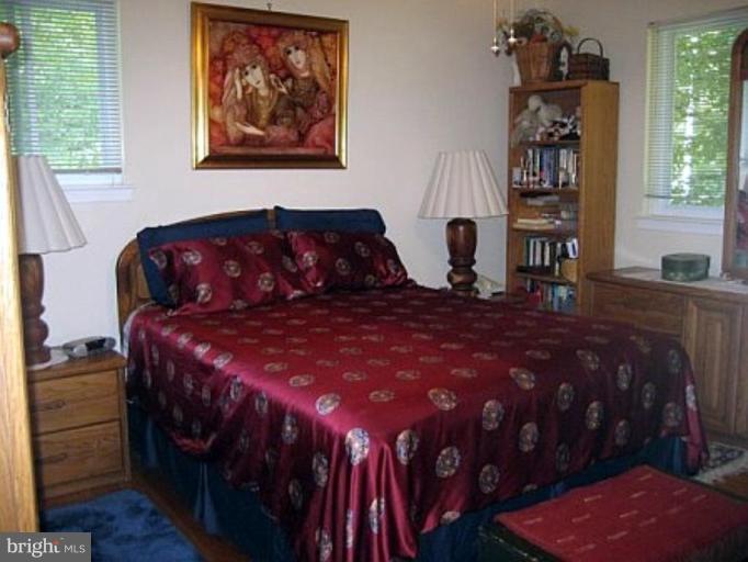 8417 Thames Street Springfield, VA 22151 - Photo 8 of 16 a large bed sitting in a bedroom next to a window