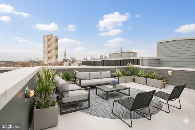 a balcony with furniture and city view