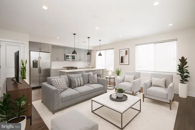a living room with furniture white walls and white walls