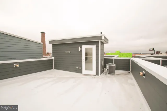 a city street lined with parked cars front of buildings