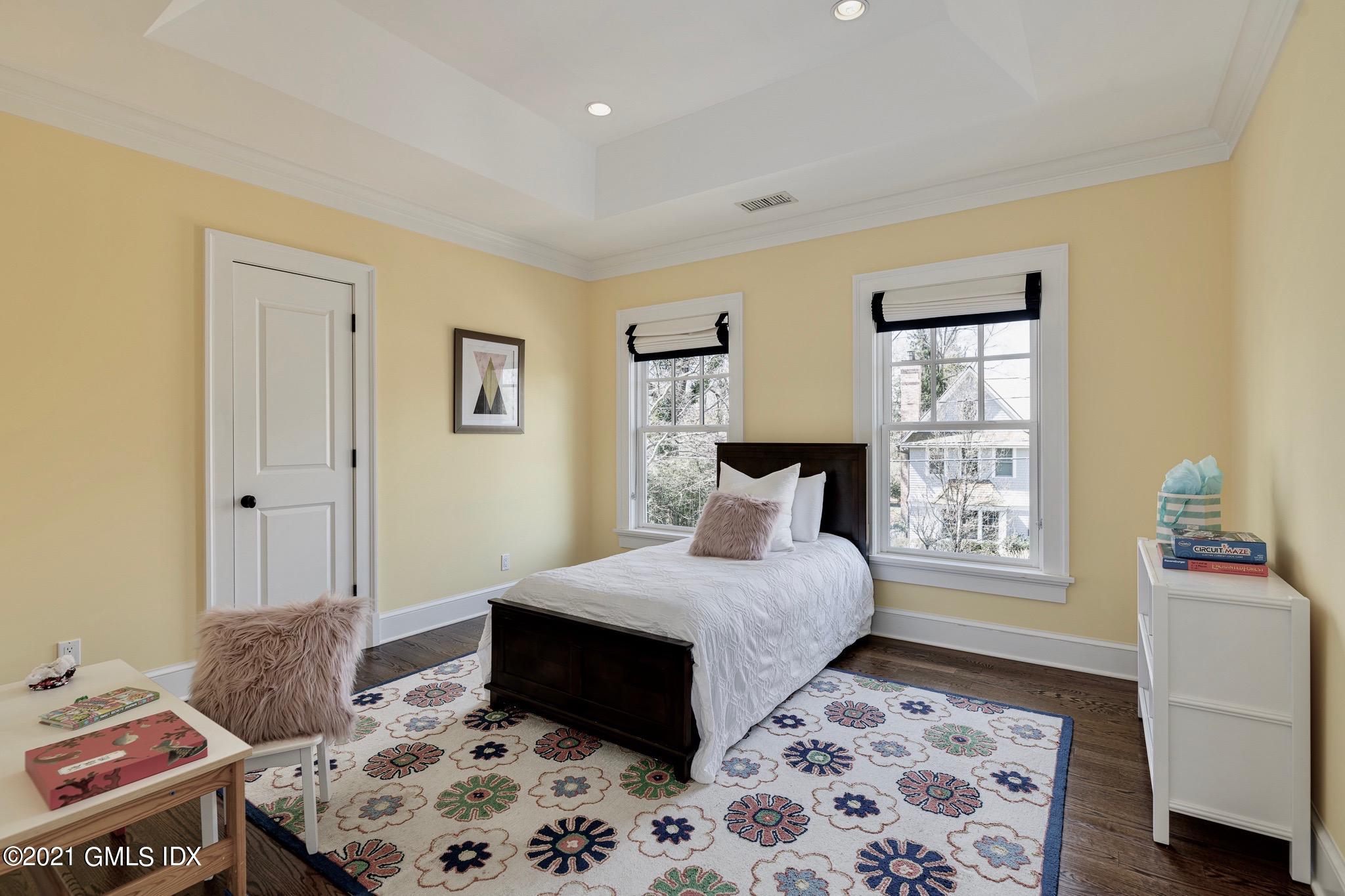 5 Gilliam Lane Riverside, CT 06878 - Photo 23 of 46 a bedroom with a bed and wooden floor