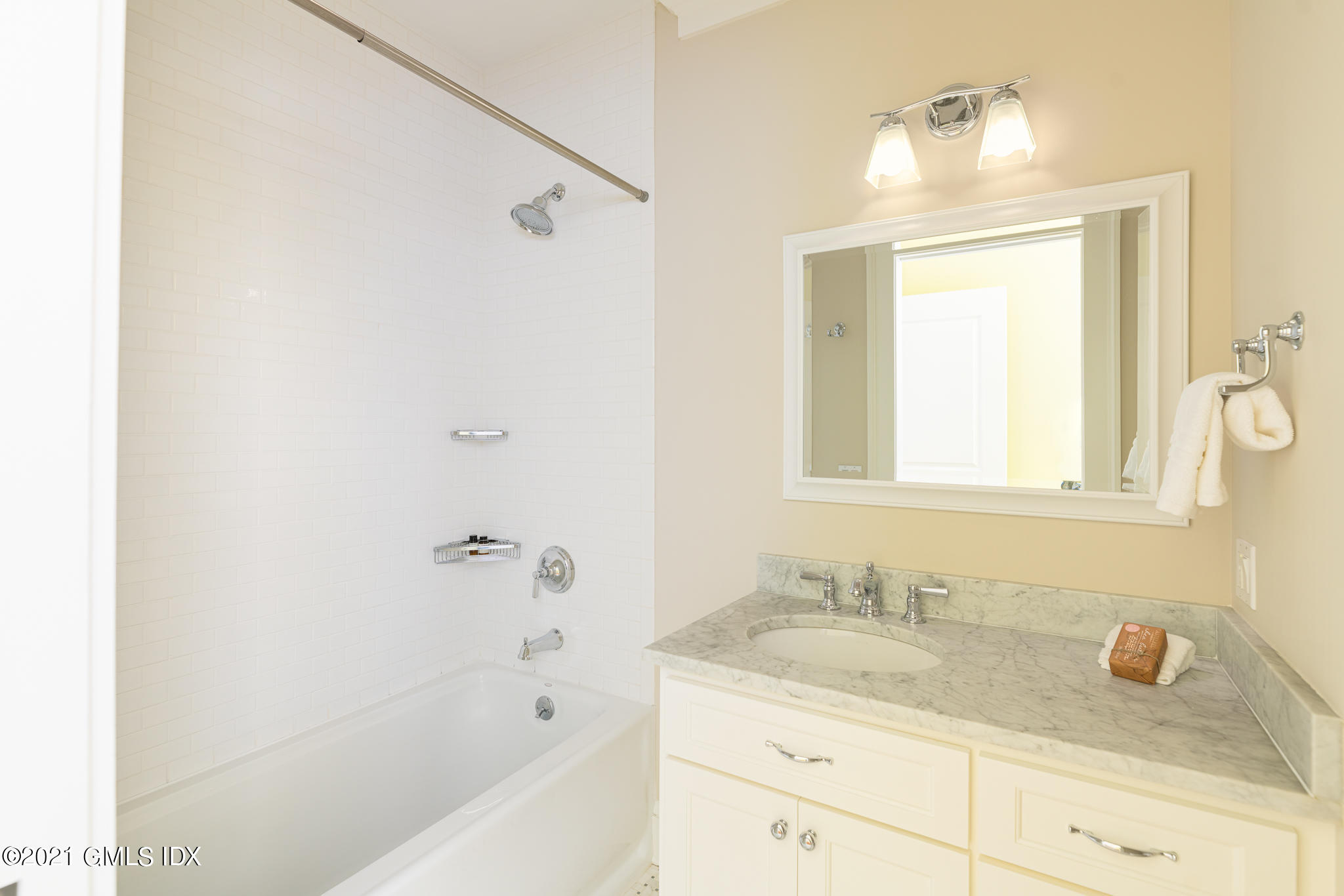 5 Gilliam Lane Riverside, CT 06878 - Photo 25 of 46 a bathroom with a granite countertop sink a mirror and a bathtub