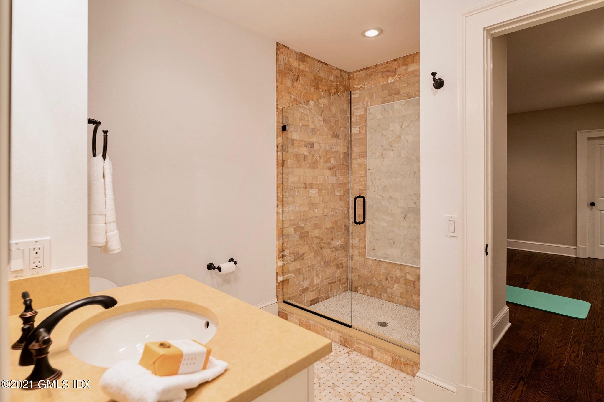 5 Gilliam Lane Riverside, CT 06878 - Photo 29 of 46 a bathroom with a tub and shower