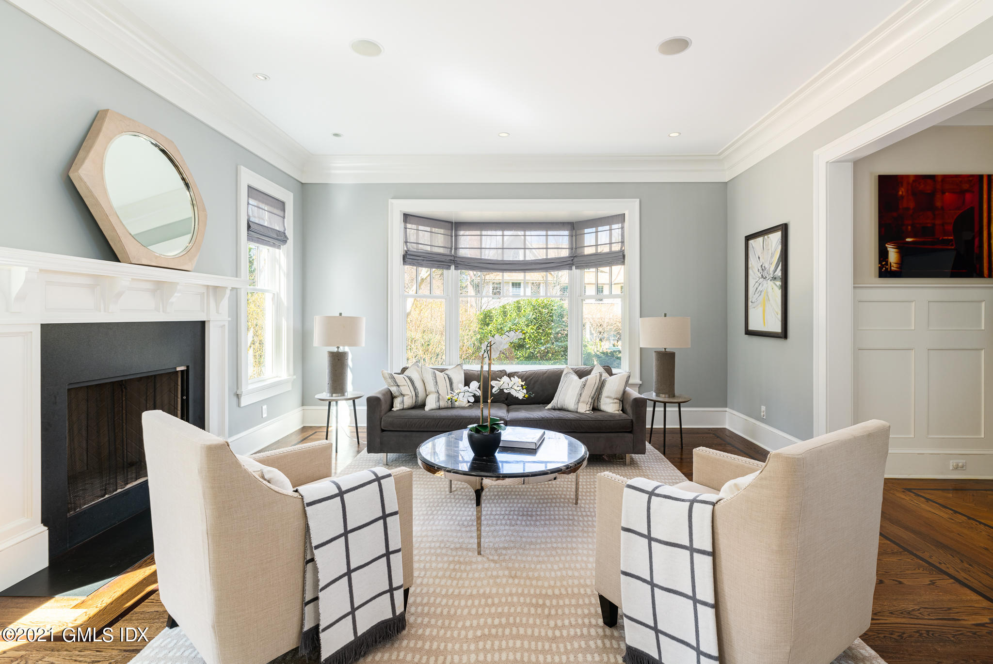 5 Gilliam Lane Riverside, CT 06878 - Photo 6 of 46 a living room with furniture a fireplace and a large window