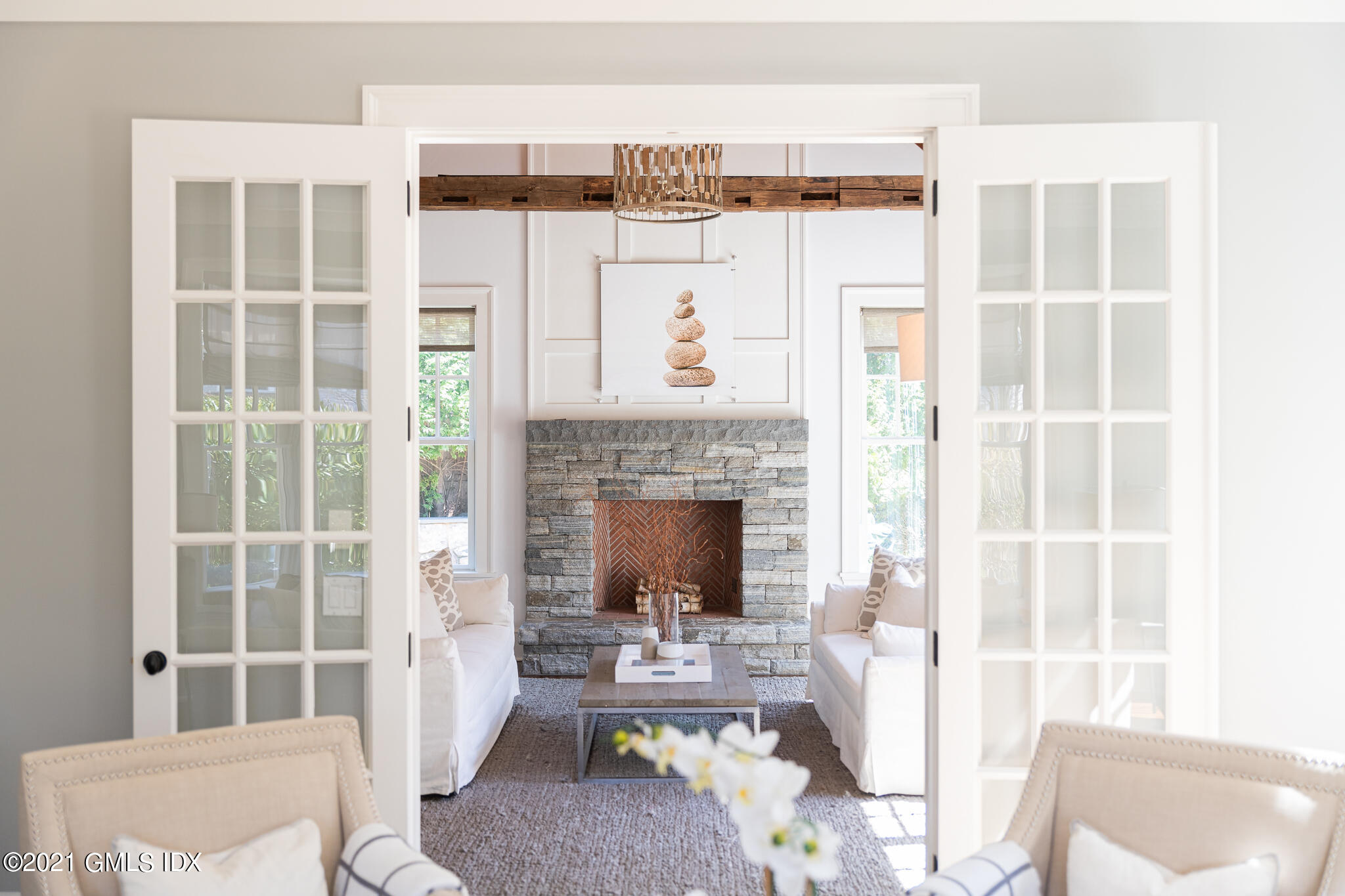 5 Gilliam Lane Riverside, CT 06878 - Photo 7 of 46 a living room with furniture a fireplace and a table
