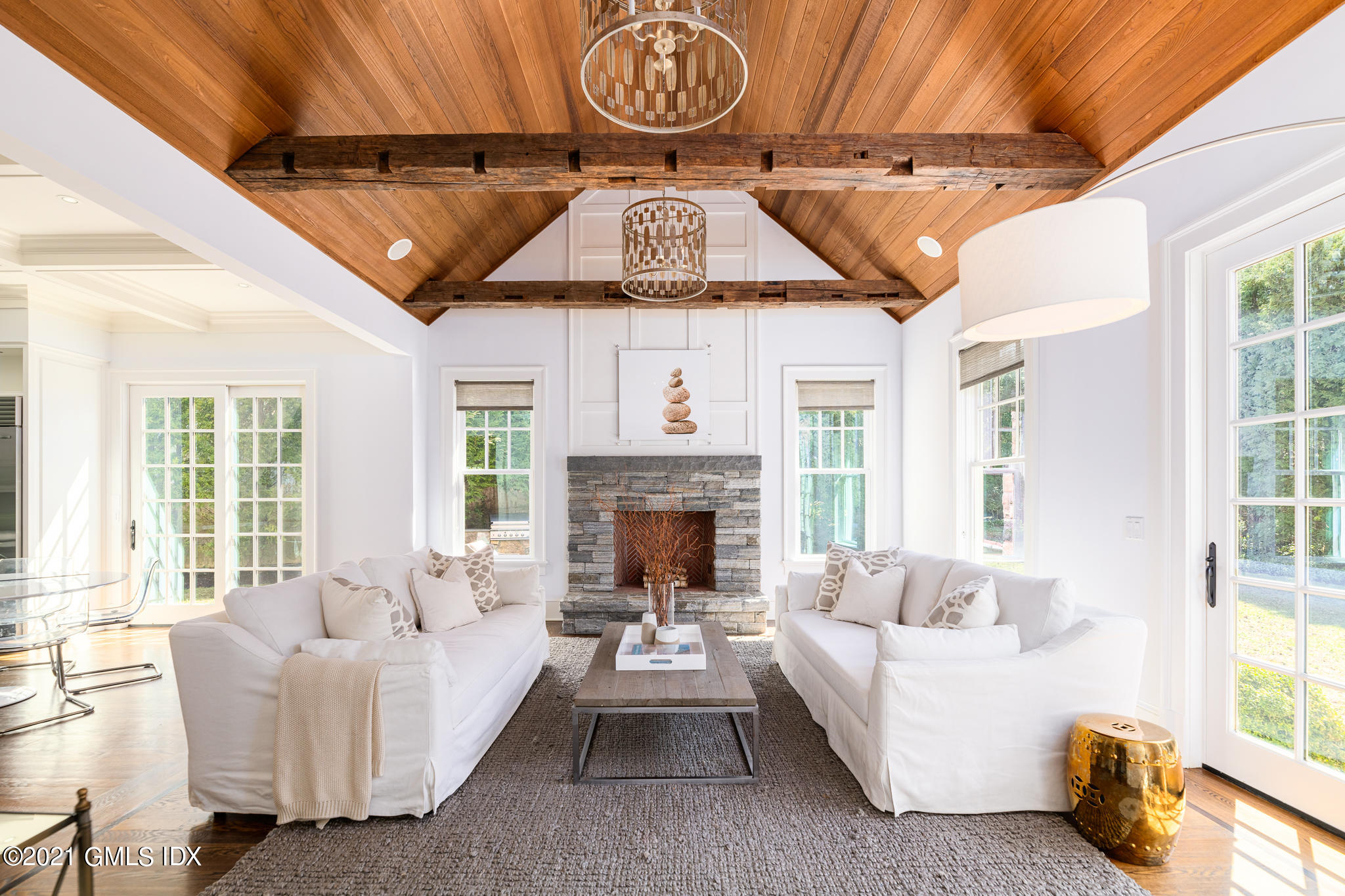 5 Gilliam Lane Riverside, CT 06878 - Photo 8 of 46 a living room with furniture a fireplace and a large window