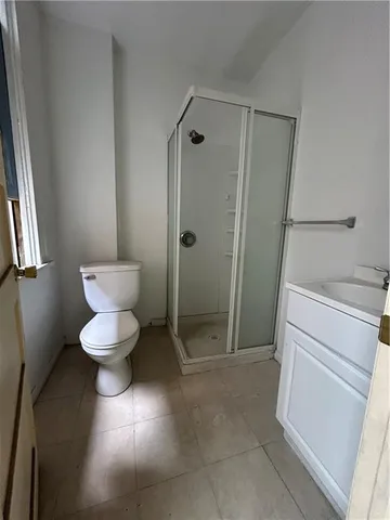 a bathroom with a toilet and a shower