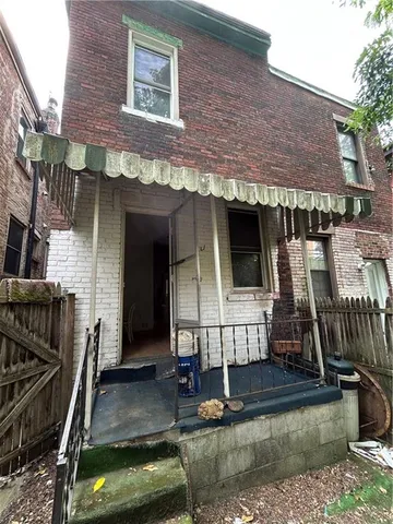 a view of house with swimming pool and porch