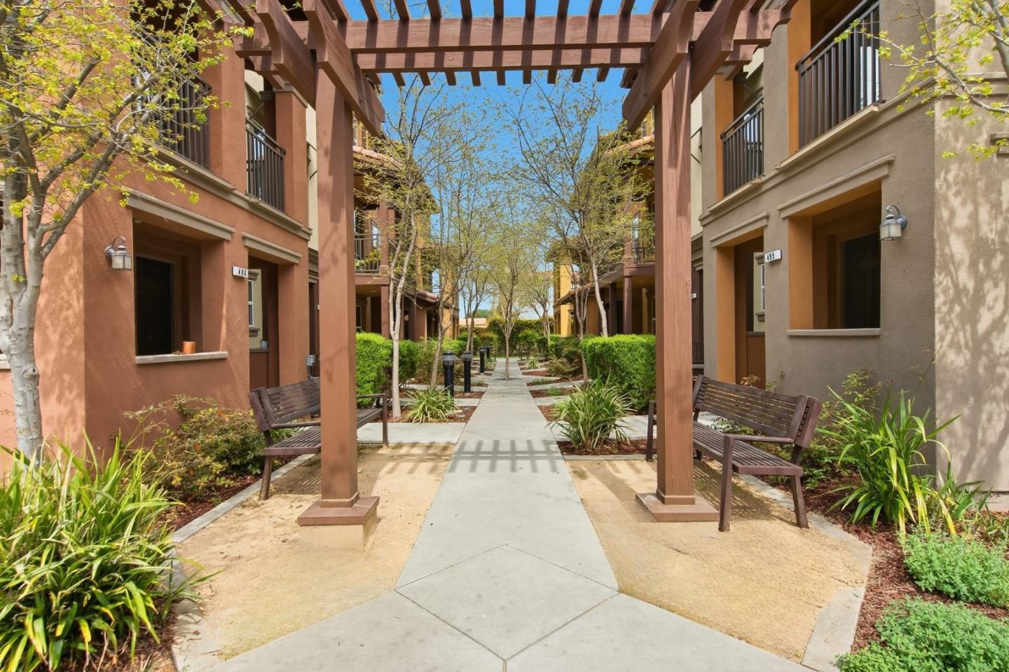 478 Rialto Place San Jose, CA 95128 - Photo 2 of 26 a view of a building with potted plants and a fountain