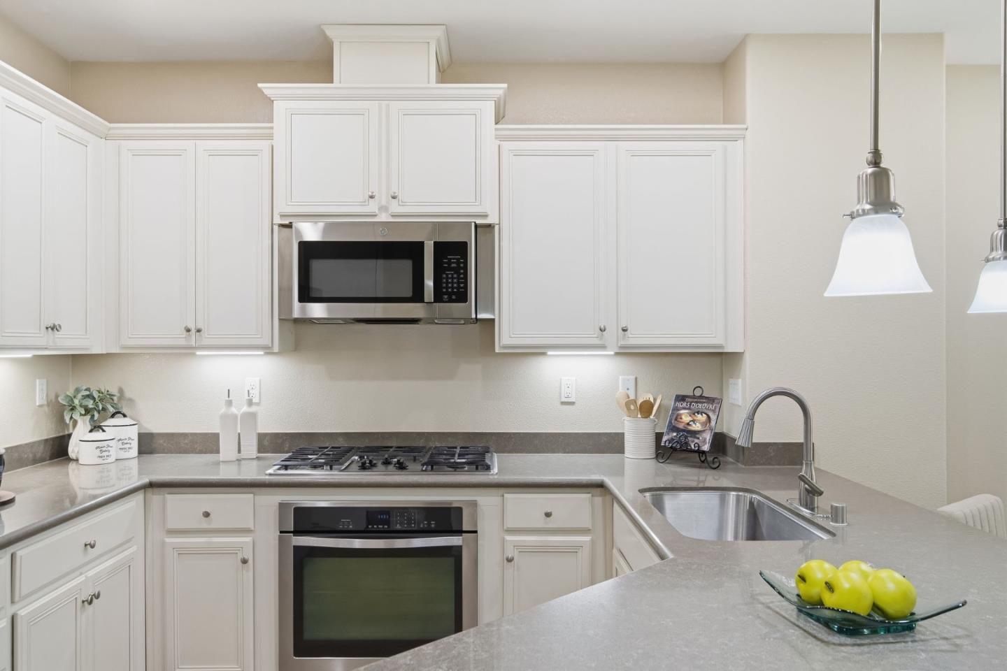 478 Rialto Place San Jose, CA 95128 - Photo 4 of 26 a kitchen with granite countertop a stove a sink and a white cabinets
