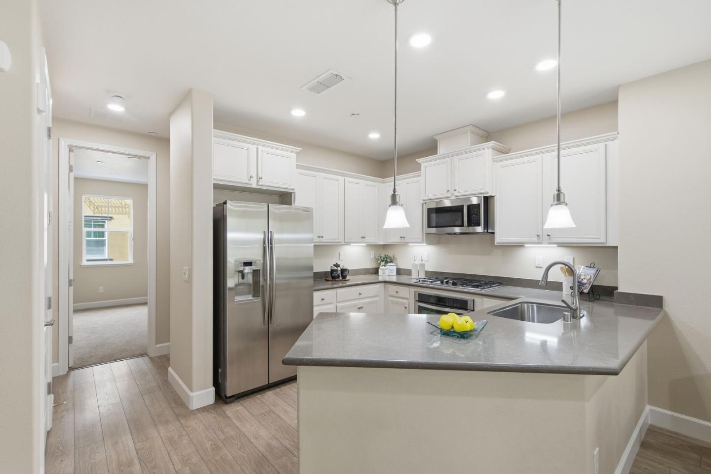 478 Rialto Place San Jose, CA 95128 - Photo 5 of 26 a kitchen with stainless steel appliances granite countertop a sink refrigerator and cabinets