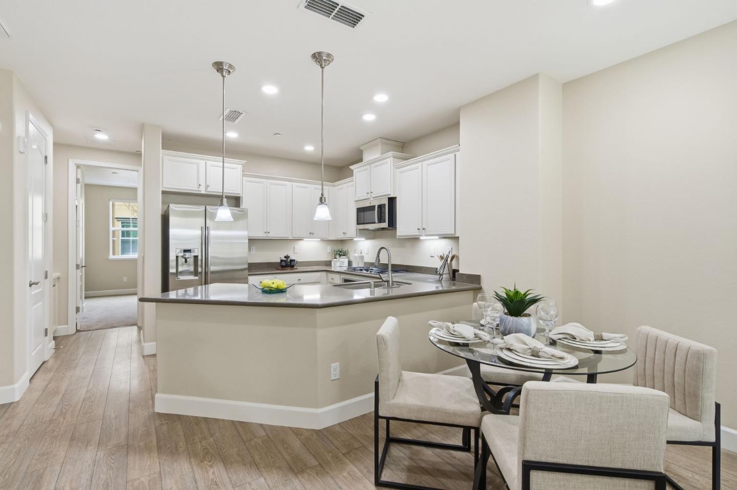 478 Rialto Place San Jose, CA 95128 - Photo 6 of 26 a kitchen with kitchen island stainless steel appliances a dining table and chairs