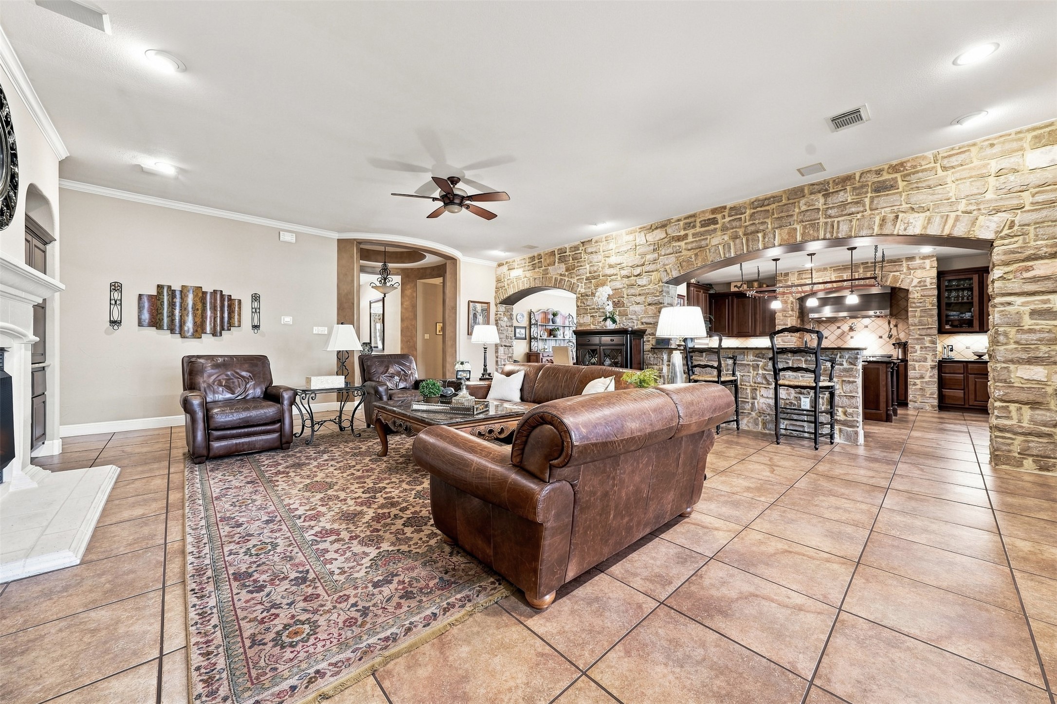 402 Ridgetop Bend Cedar Park, TX 78613 - Photo 11 of 40 Stone arches and tile flooring create an inviting transition between living space and kitchen.