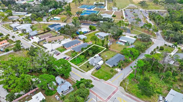 an aerial view of residential houses with outdoor space and street view