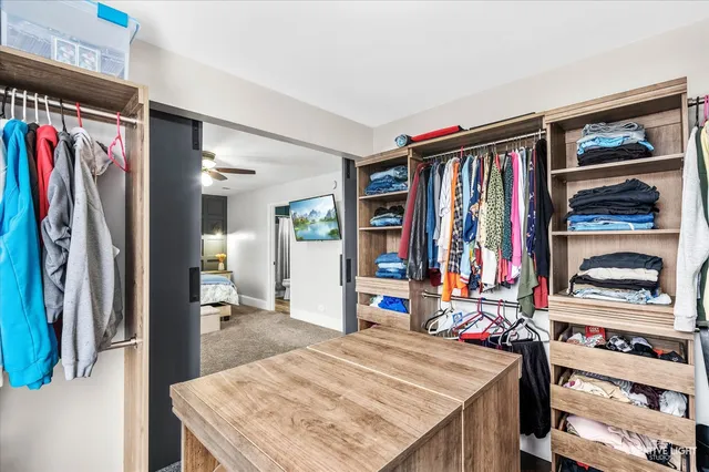 a bedroom with a large bed and a mirror