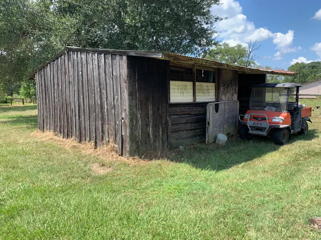 a view of a house with a yard and sitting area