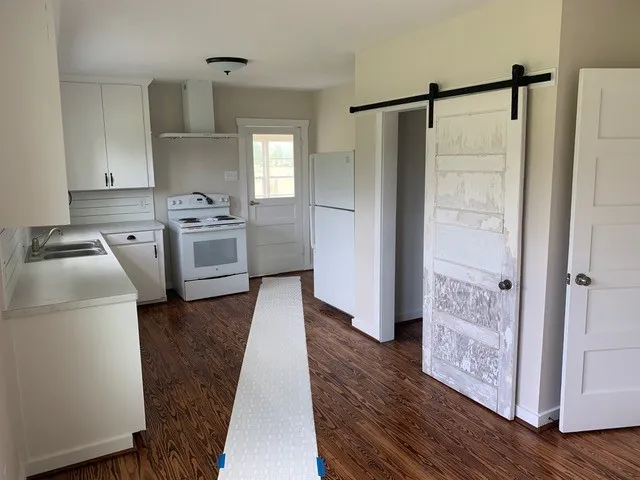 a kitchen with white cabinets and stainless steel appliances