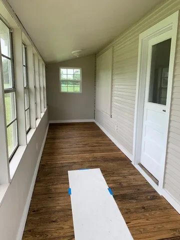 an entryway with wooden floor and stairs