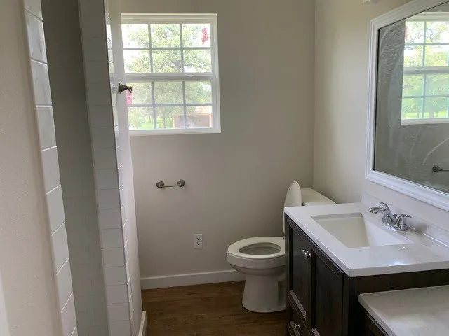 a white toilet sitting next to a bathroom sink