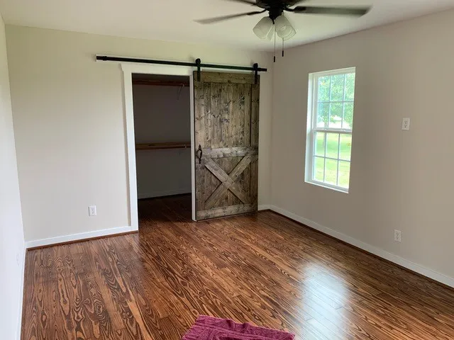 wooden floor in an empty room with a window