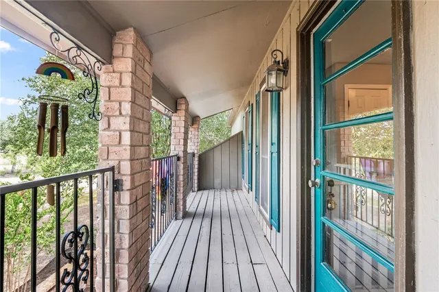 a view of balcony with wooden floor