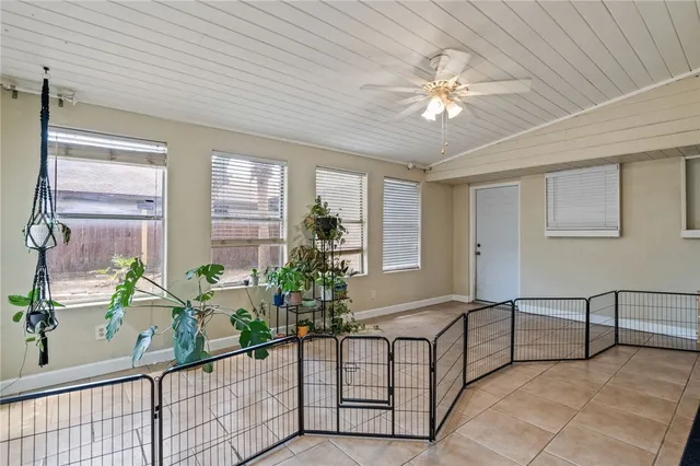 a living room with furniture and flowers