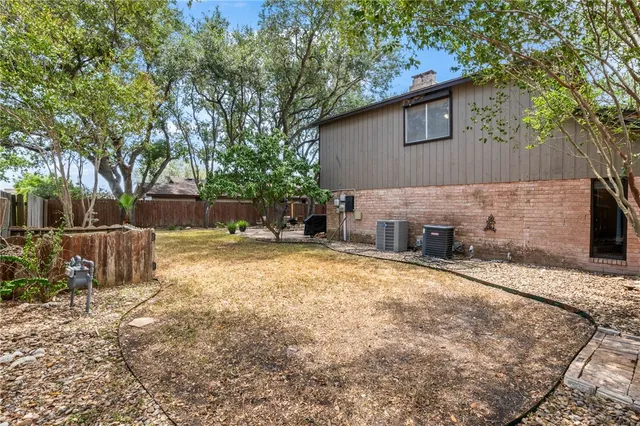an aerial view of a house with a yard and lake view