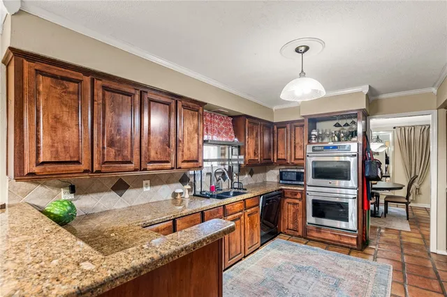 a kitchen with stainless steel appliances granite countertop a sink counter space cabinets and a window
