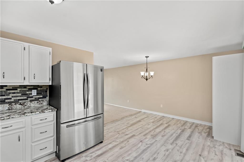 226 Briar Path Imperial, PA 15126 - Photo 11 of 33 a kitchen with cabinets stainless steel appliances and wooden floor