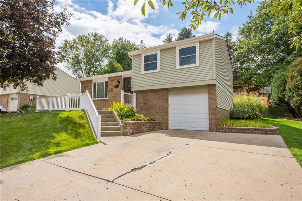226 Briar Path Imperial, PA 15126 - Photo 2 of 33 a front view of a house with a garden and yard
