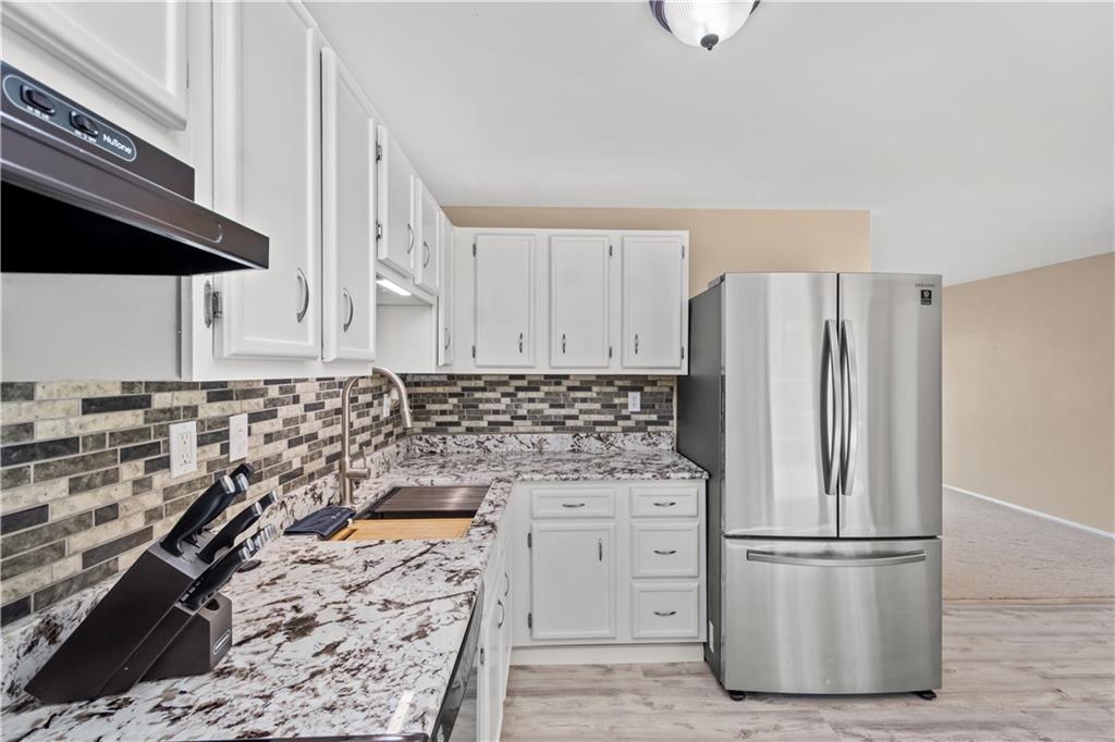 226 Briar Path Imperial, PA 15126 - Photo 10 of 33 a kitchen with a refrigerator and a stove top oven