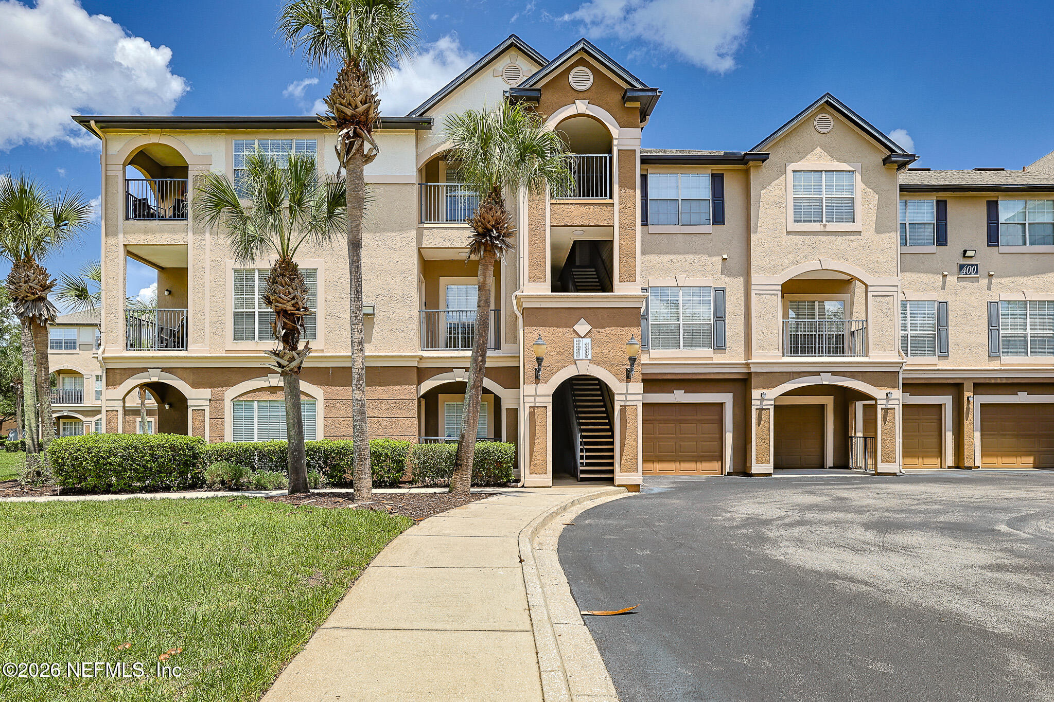 10961 Burnt Mill Road, Unit 426 Jacksonville, FL 32256 - Photo 1 of 24 a front view of a house with a yard