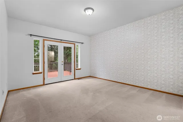 an empty room with sliding glass door and shower