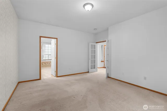 a view of an empty room and a window