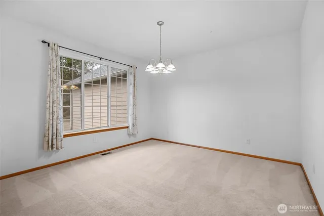 a view of a room with windows and ceiling fan
