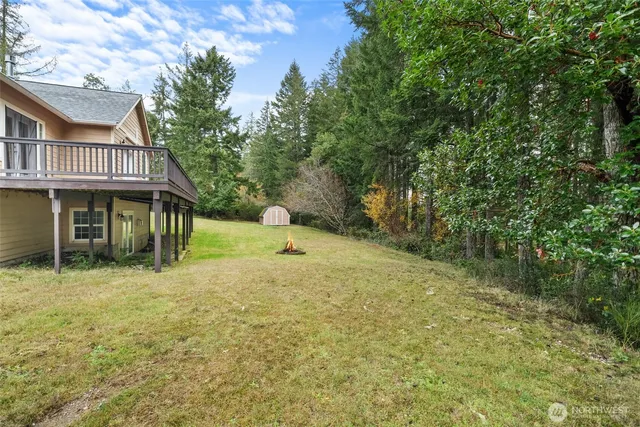 an aerial view of a house with a yard basket ball court and outdoor seating
