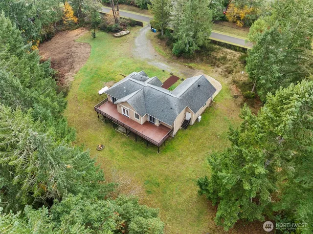 an aerial view of a house with a yard basket ball court and outdoor seating