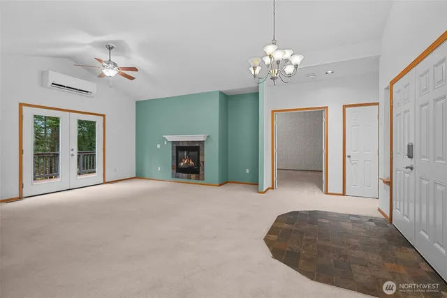 a living room with fireplace and chandelier