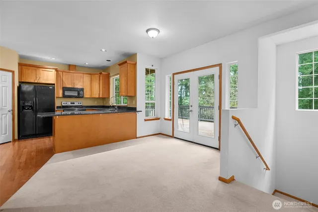 a kitchen with stainless steel appliances granite countertop a refrigerator and a stove top oven