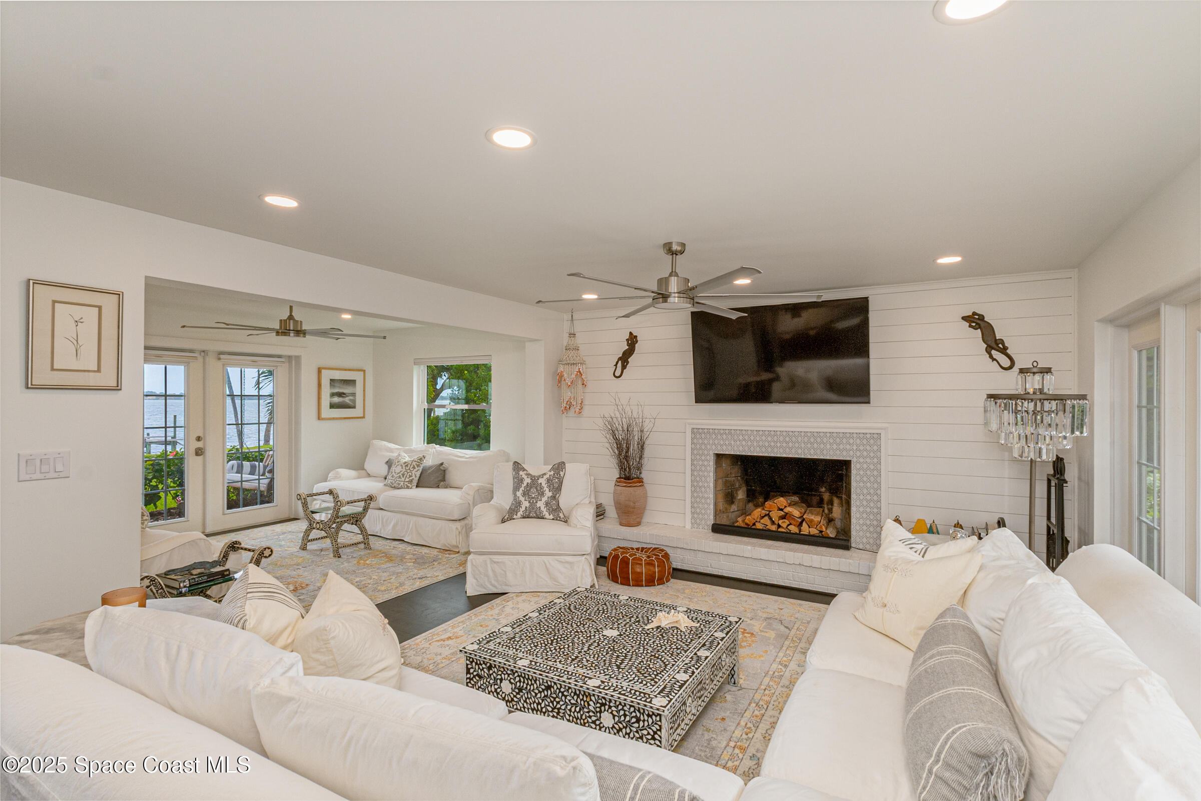 1307 Rockledge Drive Rockledge, FL 32955 - Photo 17 of 75 a living room with furniture a fireplace and a flat screen tv