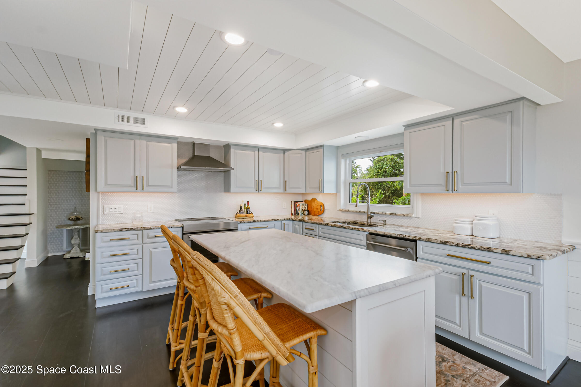 1307 Rockledge Drive Rockledge, FL 32955 - Photo 22 of 75 a kitchen with kitchen island a sink stove and cabinets