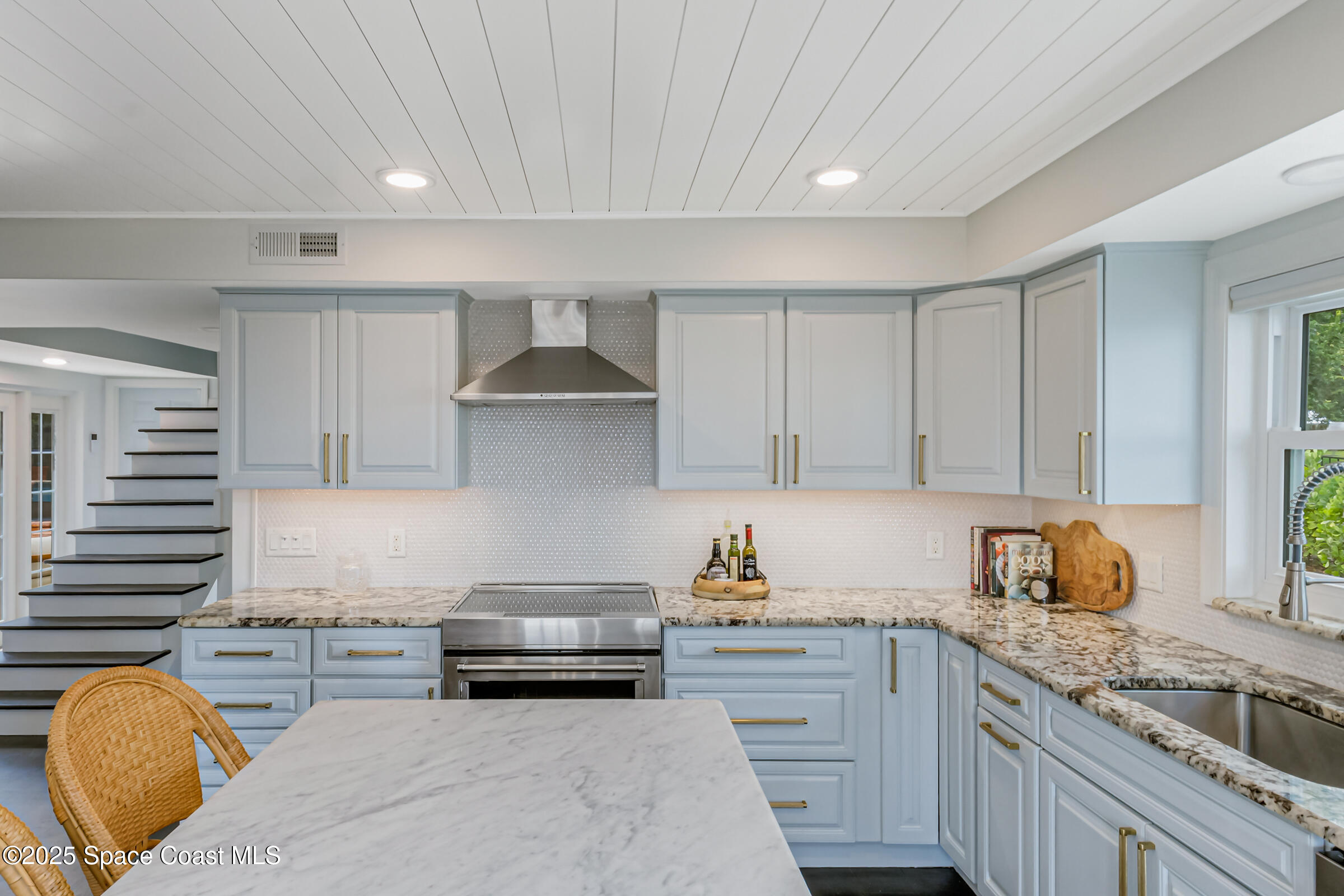1307 Rockledge Drive Rockledge, FL 32955 - Photo 23 of 75 a kitchen with kitchen island granite countertop a sink stove and cabinets