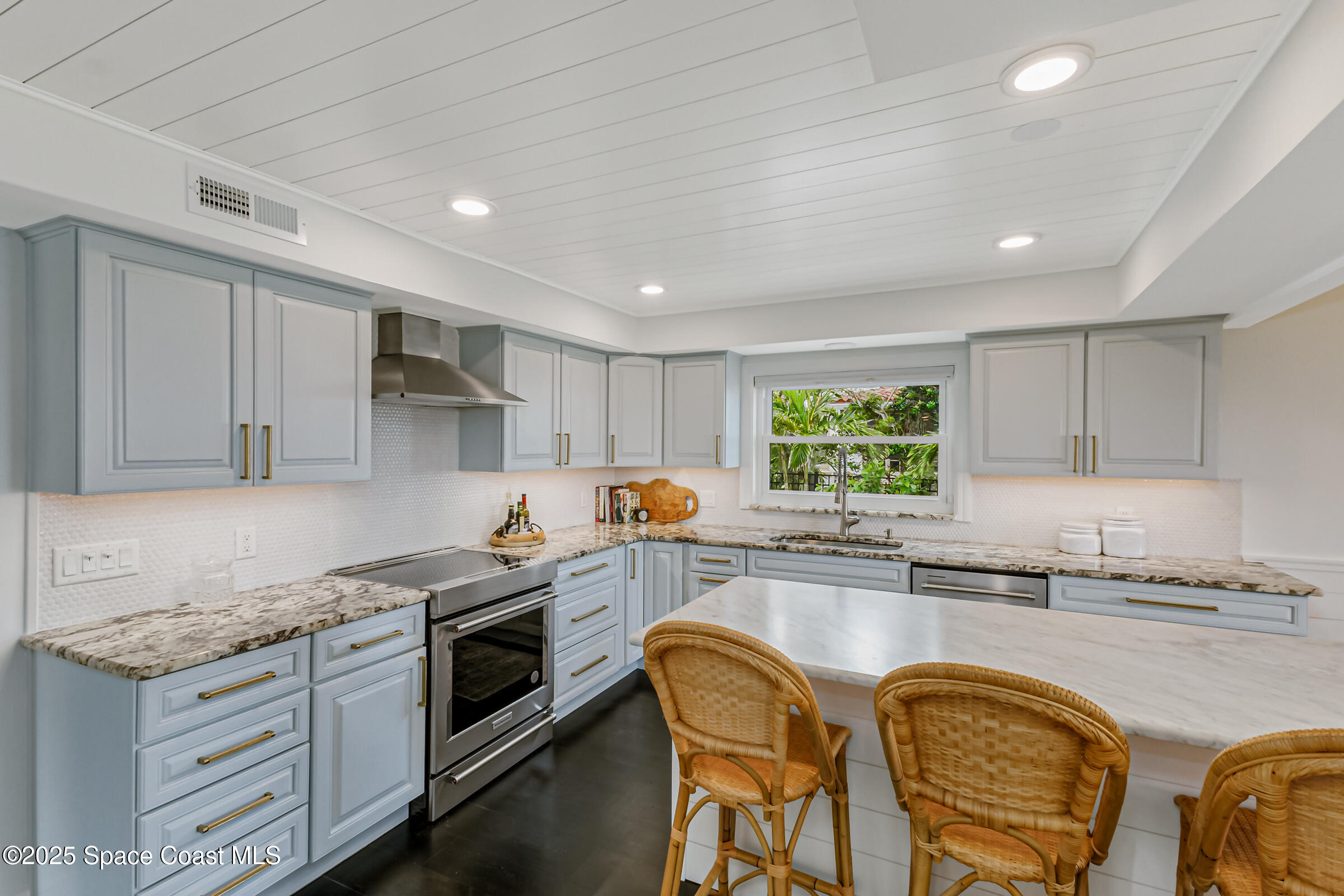 1307 Rockledge Drive Rockledge, FL 32955 - Photo 24 of 75 a kitchen with granite countertop white cabinets and stainless steel appliances